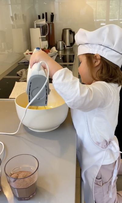 Anna as a child in the kitchen